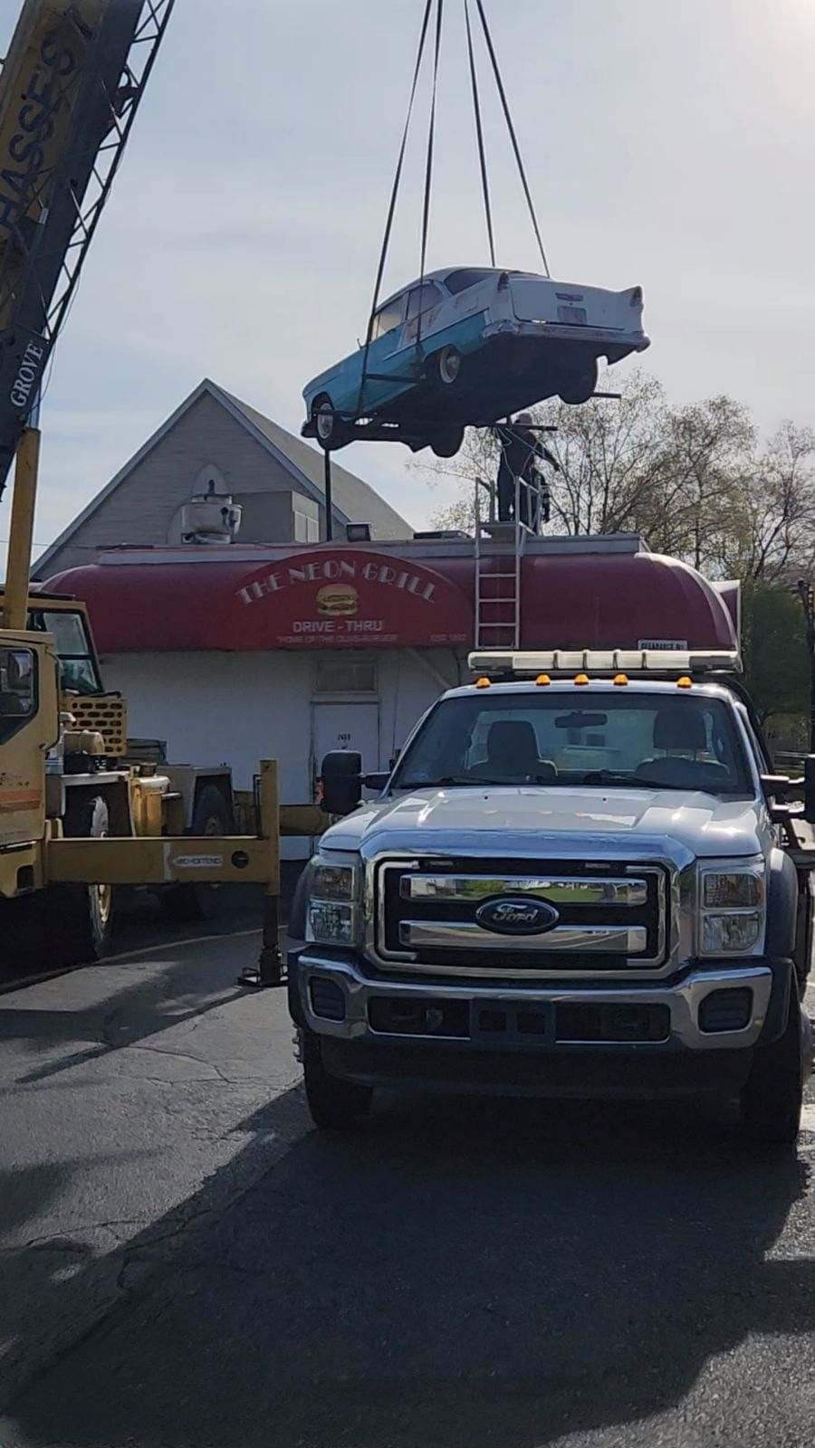 Hasse's crane lifting a classic '53 Chevy off the Neon Grill building